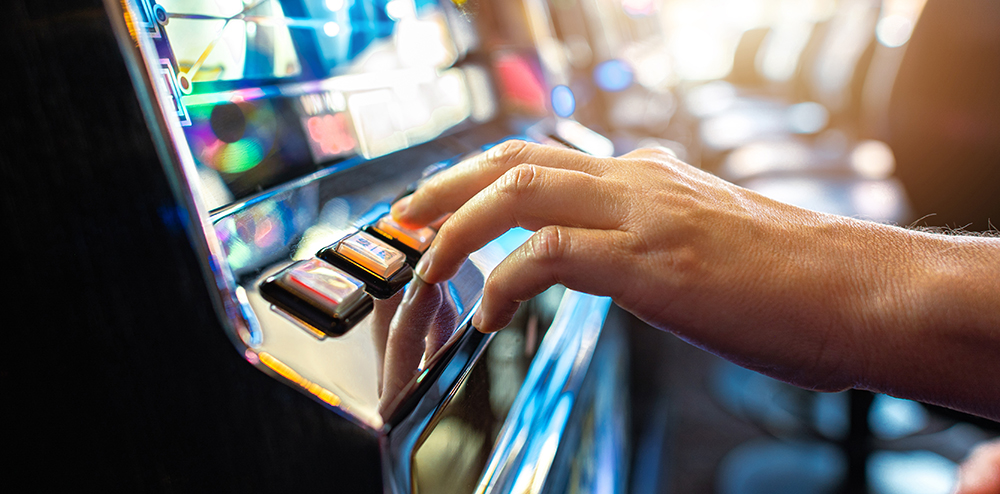 Woman Playing Classic Slot Machine Inside Las Vegas Casino. One Handed Bandit Game Play. Gambling Industry Theme.